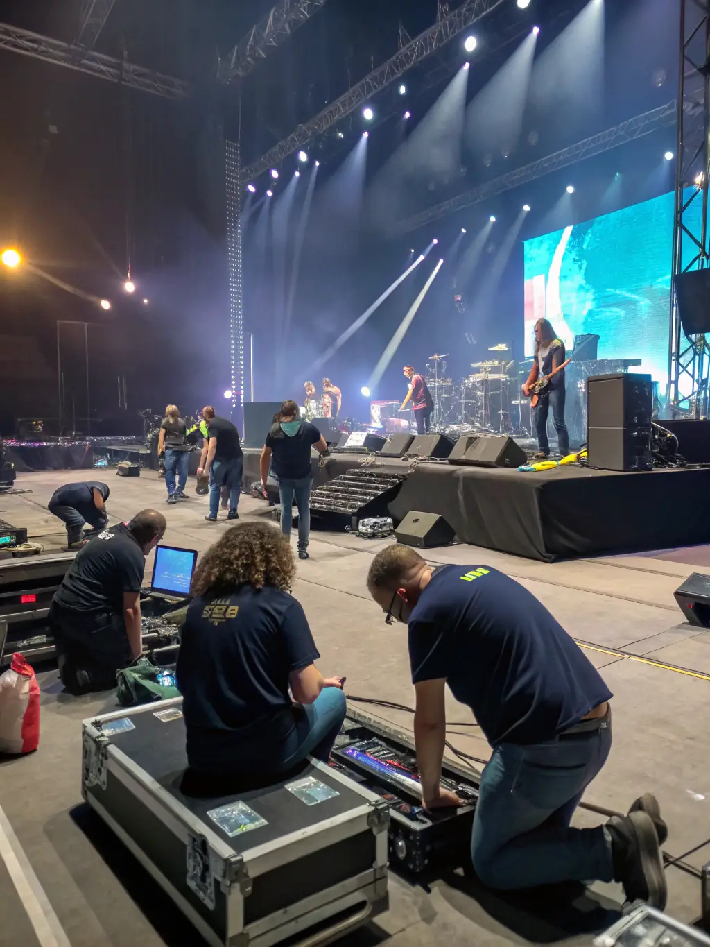 An image of volunteers setting up the stage for a DYNAMIC EVENTS community music festival, emphasizing the collaborative effort behind the events.